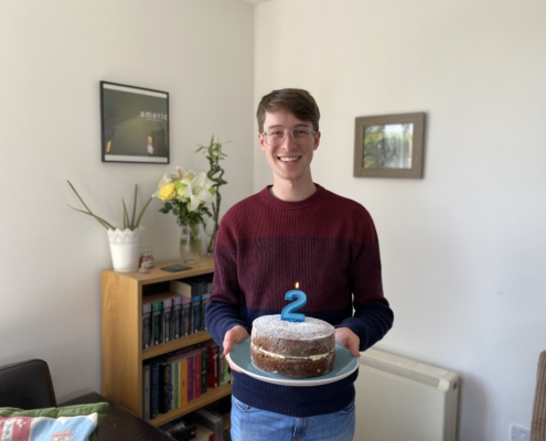 Man smiling holding cake