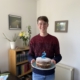 Man smiling holding cake