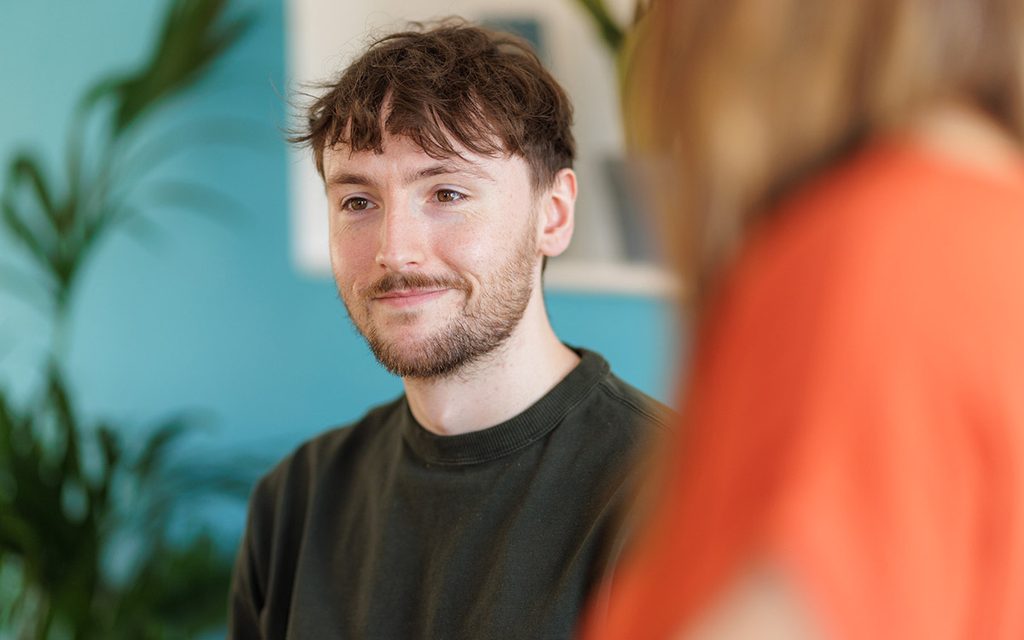 a man smiling at something off screen