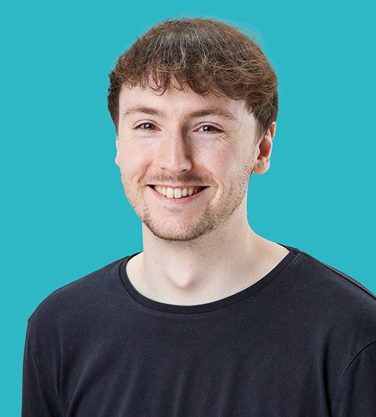 a headshot of Oliver a man with short dark hair