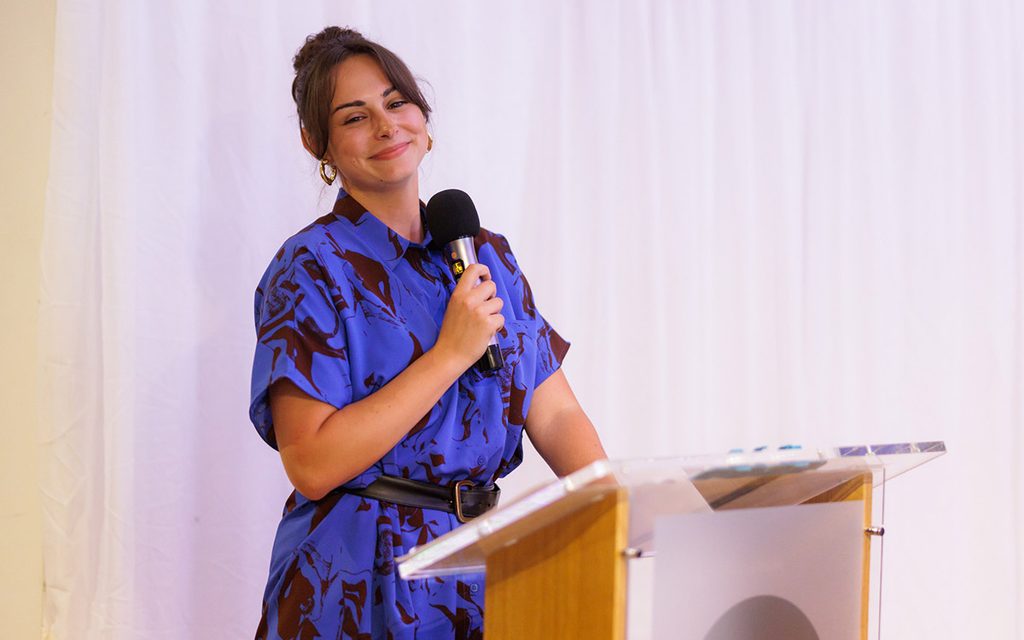 a woman making a speach at a podium