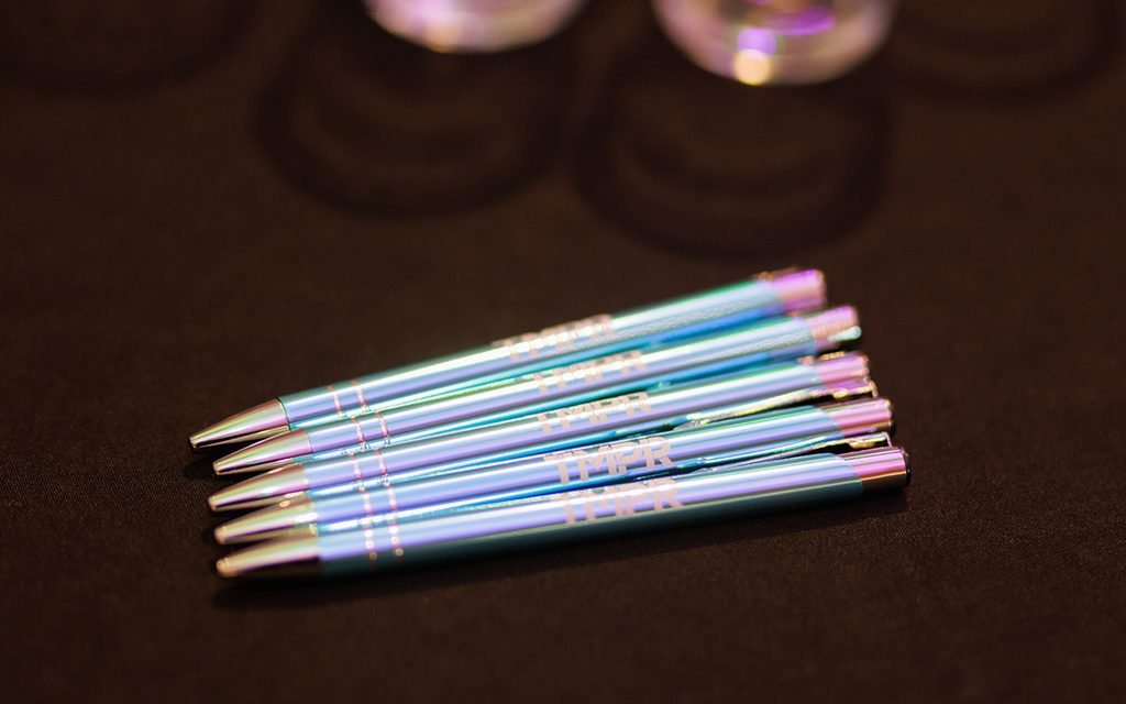 five blue metallic pens with the TMPR logo