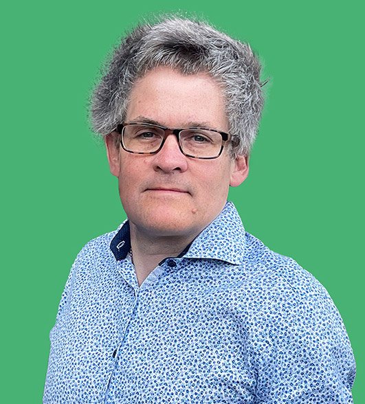 a headshot of Christopher a man with grey hair